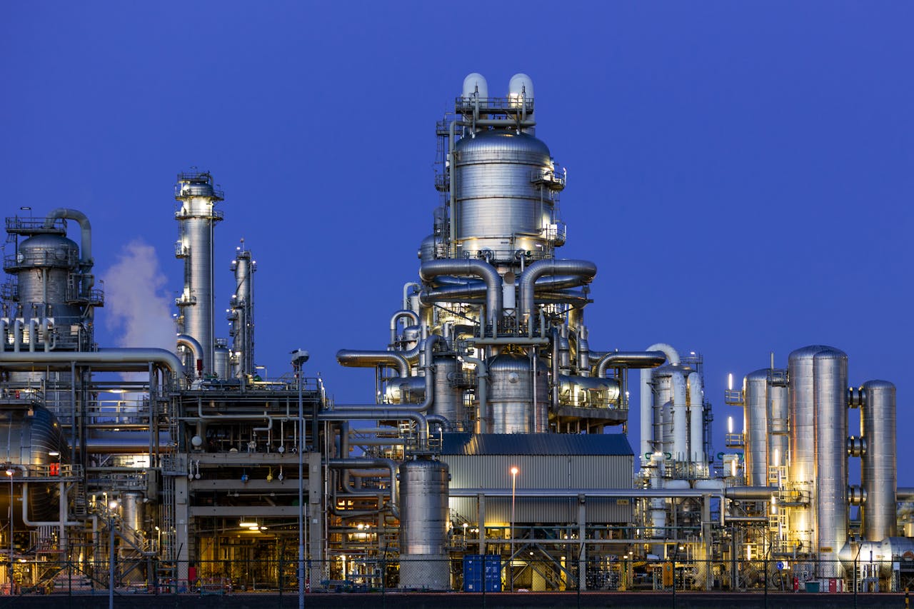 services-02 A modern industrial refinery structure under a clear twilight sky in Zuid-Holland, Netherlands.